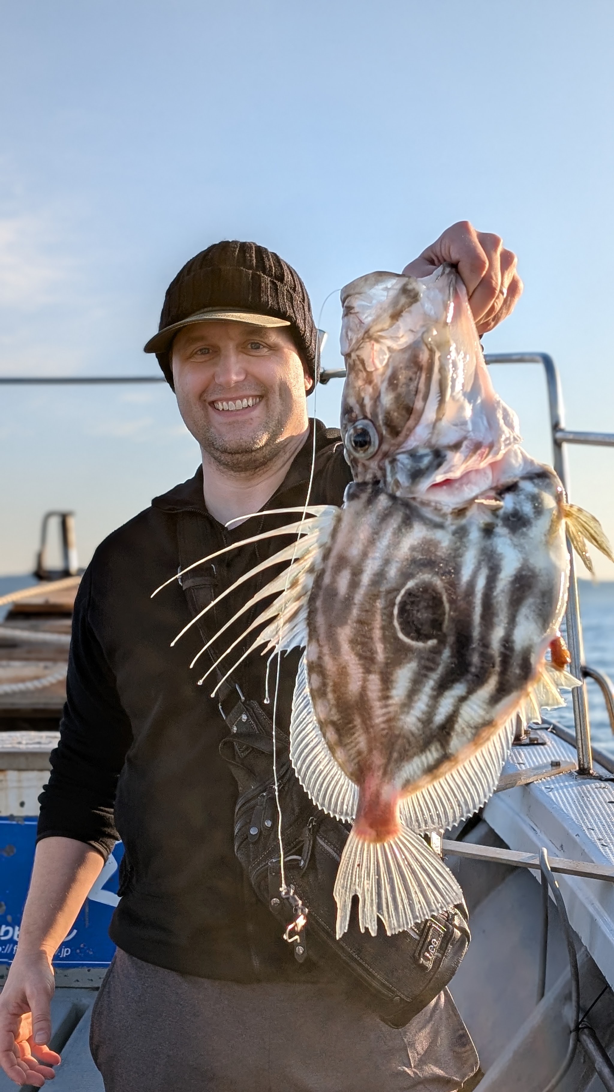 Dr. Baker with a fish he caught off the coast of Japan