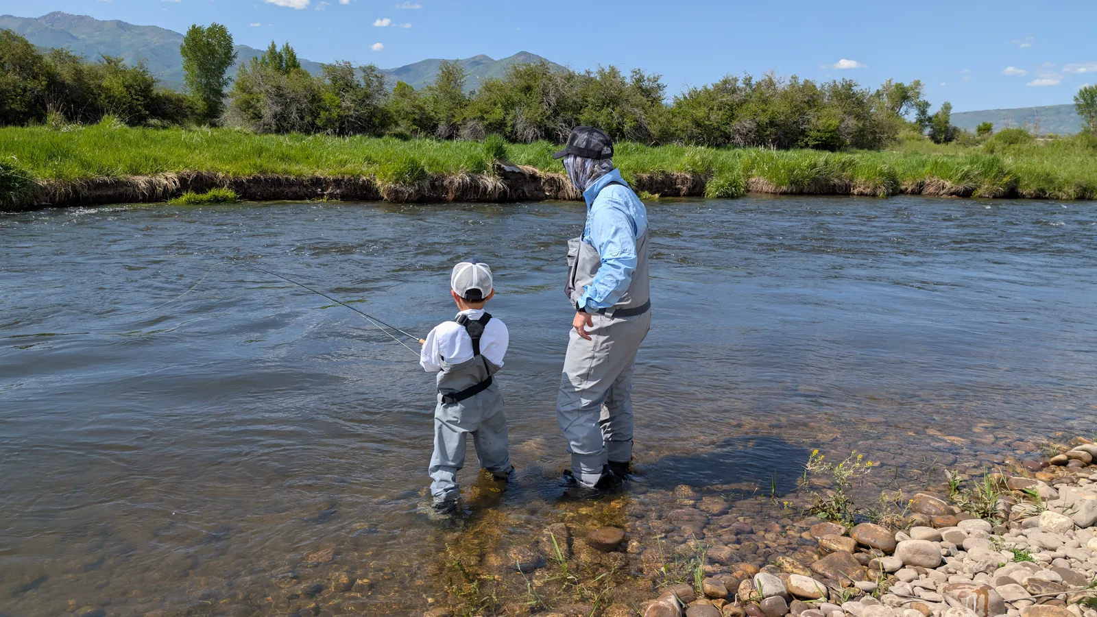 Dr. Baker and Isaac standing together in the river